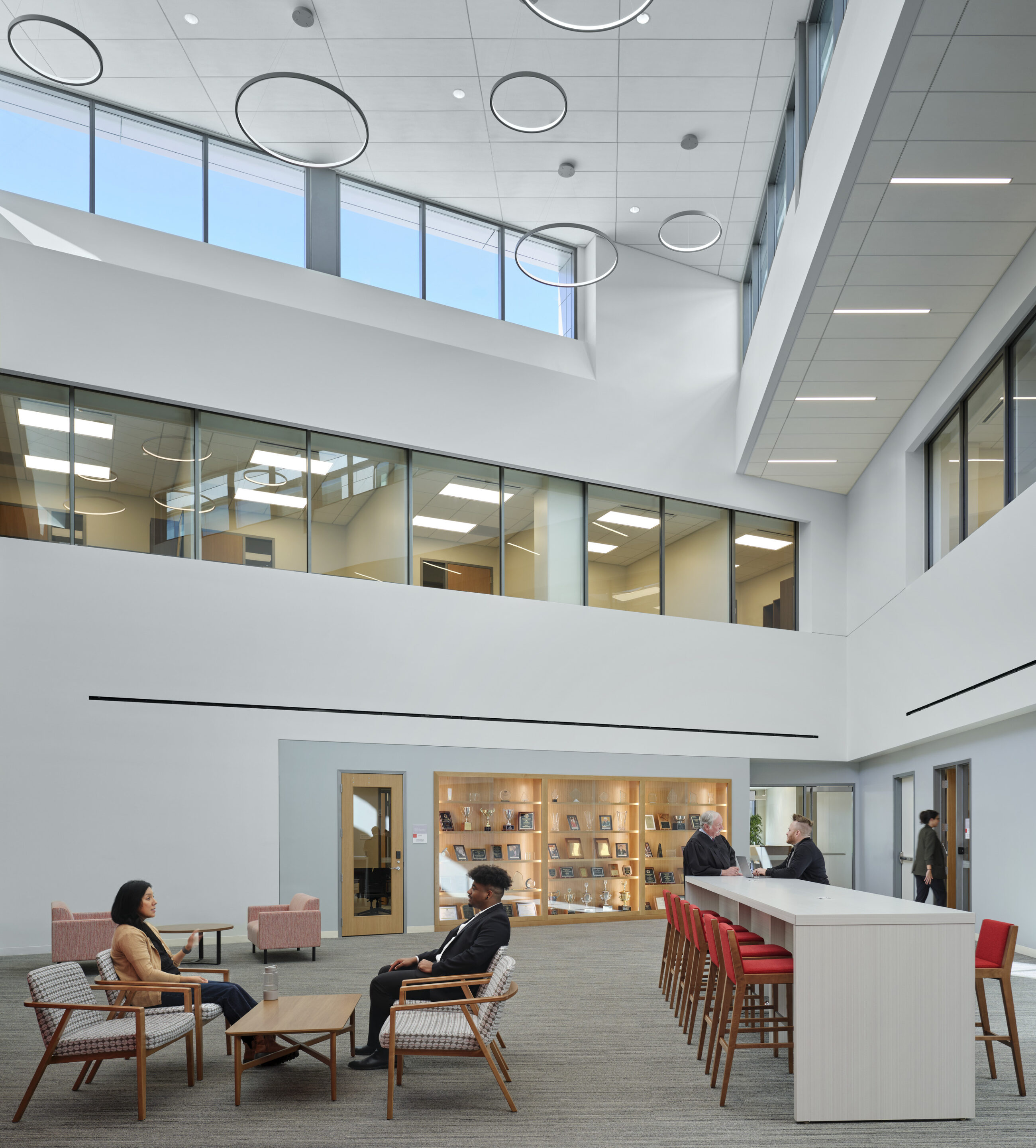 Triple height open common space with clerestory windows and views to different study spaces and offices